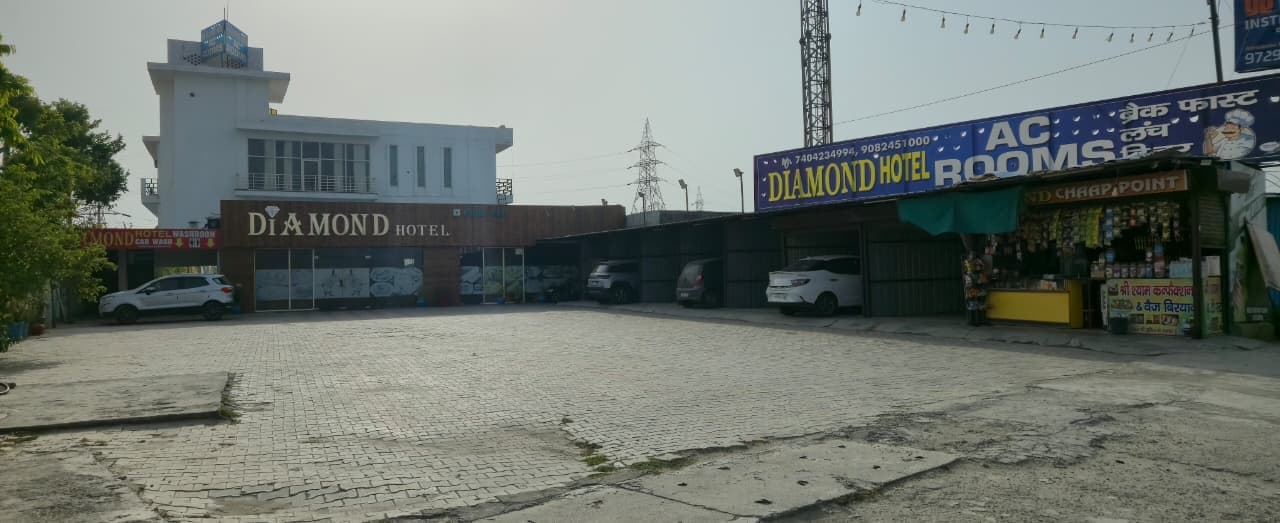 Diamond Hotel wide exterior with ample parking space in Samalkha NH-44